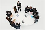 Business associates working together in groups around table