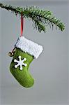 Christmas stocking ornament hanging on branch