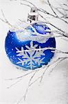 Blue bauble in snow