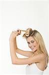 Teen girl rolling her hair with curlers