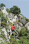 Hikers climbing rocks, rear view