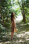 Young woman standing in woods