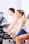 Young couple on bikes indoors