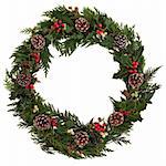 Christmas decorative wreath of holly, ivy, mistletoe, cedar and leyland leaf sprigs with pine cones over white background.