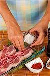 Using coarse salt to season a raw beef cut