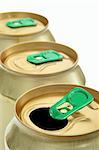 three gold-colored cans in a row