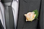 rose boutonniere flower on groom's wedding coat