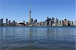 Photo of the Toronto skyline under a clear sky.