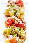 Fresh green and red heirloom tomato bruschetta