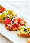 Fresh green and red heirloom tomato bruschetta