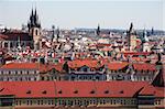 View of red tile roofs and high gothic towers in Prague, Czech Republic