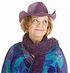 Grinning European senior woman in purple hat