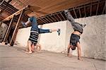 Two European Capoeria artists performing headstands