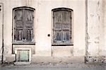 Old grungy wall with closed windows