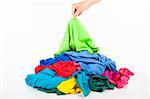 hand pick up a shirt in pile of colorful clothes