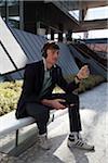 Businessman Listening to Music Outdoors