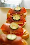 Canapes with ham, tomatoes and cucumber