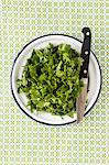 Freshly chopped coriander on a plate with a knife