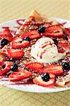 Crepe Topped with Fresh Strawberries and Blueberries and a Scoop of Ice Cream
