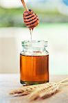 Jar of honey with honey dipper