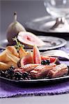 Duck breast with roast potatoes, figs and berry compote