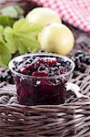 Blackcurrant and apple jam in a glass jar