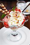 Strawberry sundae with cream and wafers