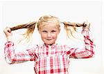 Portrait of girl holding pigtails, studio shot