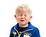 Portrait of boy with eyes closed, studio shot