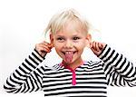 Portrait of girl sticking out tongue, studio shot