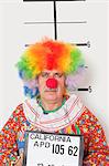 Portrait of senior clown posing for mug shot