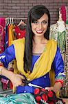 Portrait of an Indian female dressmaker cutting cloth