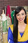 Portrait of a pretty Indian female dressmaker smiling