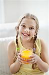 Portrait of happy young girl drinking orange juice