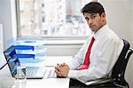 Portrait of a confident businessman at office desk