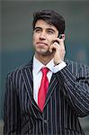 Young Indian businessman communicating on cell phone