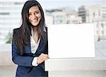 Portrait of a young Indian businesswoman holding Moodboard sign