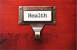 Lustrous Wooden Cabinet with Health File Label in Dramatic LIght.