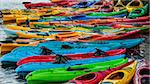 Colorful fiberglass kayaks tethered to each other