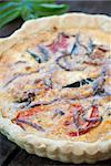 Golden crusted quiche with heirloom tomatoes, onions and herbs