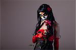 Sugar skull girl holding red rose, Day of the Dead Halloween theme