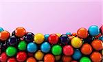 many gumballs isolated on pink background