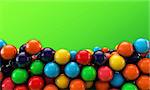 many gumballs isolated on green background
