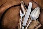 Vintage silverware on rustick wooden plate