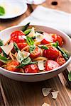 spaghetti with green asparagus and cherry tomatoes topped with basil and parmesan