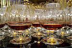 Glasses with cognac on table - party background