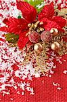 Red christmas decoration with flowers and snow.