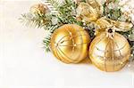 Christmas decoration. Golden christmas baubles and ribbon close up.