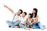 Happy Asian family sitting on floor and pointing over white background
