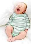 Yawning New Born Baby in the Bed